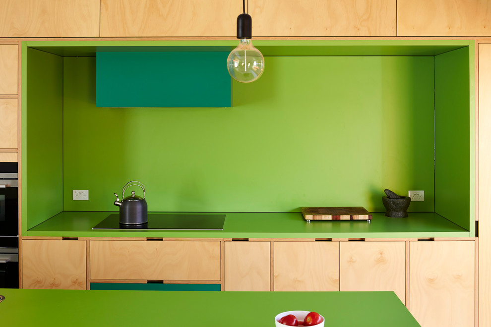 Design ideas for a modern kitchen in Adelaide with green splashback, black appliances and with island.