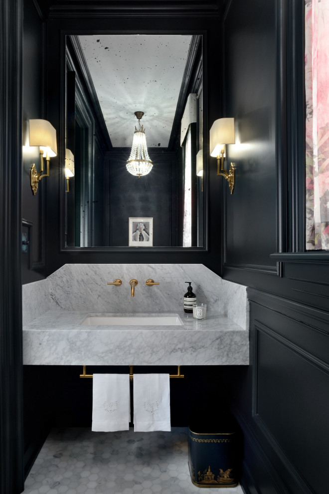 This is an example of a small traditional powder room in Toronto with a one-piece toilet, black walls, marble floors, an undermount sink, marble benchtops, white floor and white benchtops.