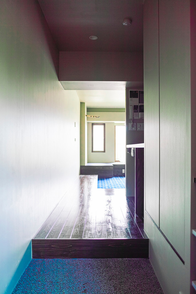 Example of a small medium tone wood floor hallway design in Tokyo with beige walls