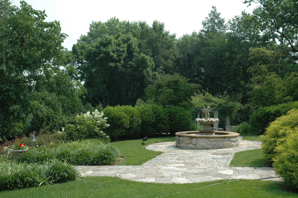 Design ideas for a large traditional backyard partial sun garden in Baltimore with natural stone pavers.