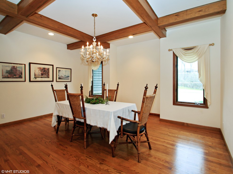 Inspiration for a traditional dining room in Milwaukee with medium hardwood floors.