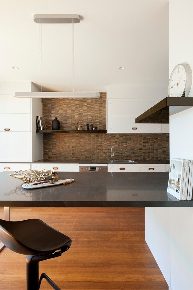 Design ideas for a large contemporary eat-in kitchen in Melbourne with a drop-in sink, white cabinets, multi-coloured splashback, medium hardwood floors, with island, shaker cabinets, solid surface benchtops, ceramic splashback, stainless steel appliances and grey benchtop.