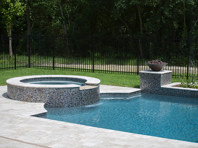 Inspiration for a mid-sized mediterranean backyard rectangular natural pool in New Orleans with a hot tub and concrete pavers.