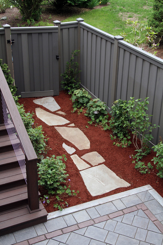 Design ideas for a mid-sized traditional backyard partial sun garden in Boston with a garden path and gravel.