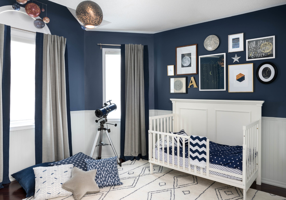 This is an example of a mid-sized contemporary nursery for boys in Toronto with blue walls and carpet.