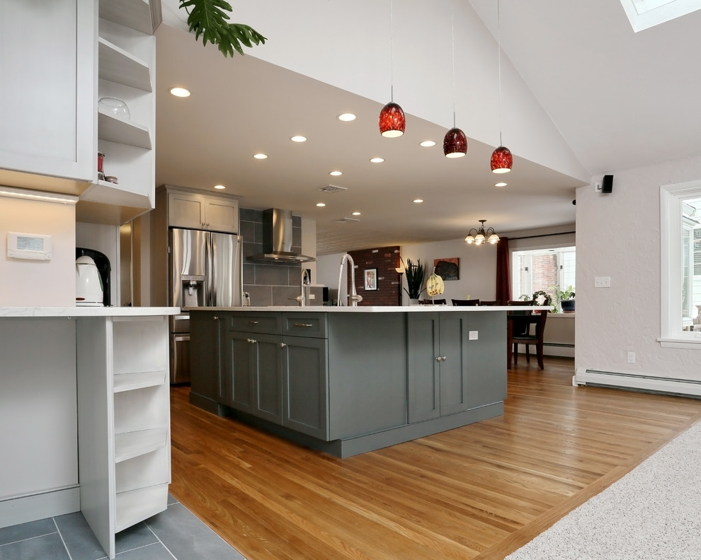 Design ideas for a modern kitchen in Boston with grey cabinets and light hardwood floors.