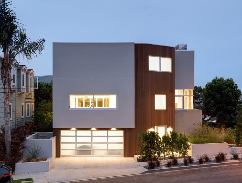 Photo of a scandinavian three-storey white house exterior in Los Angeles with mixed siding and a flat roof.