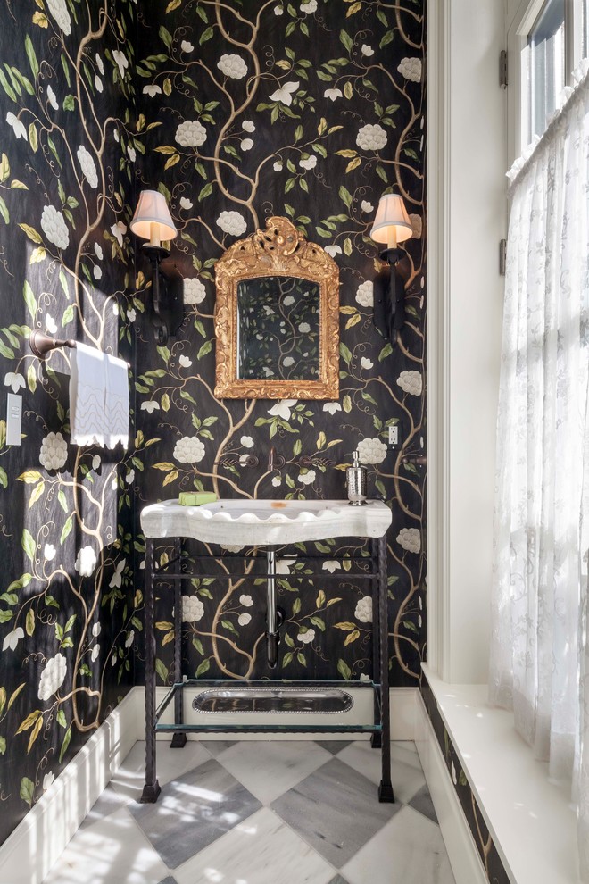 This is an example of a small traditional powder room in Other with multi-coloured walls, a console sink, multi-coloured floor and marble floors.