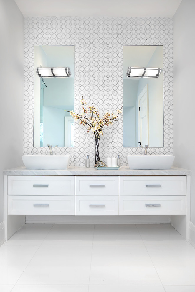 Freestanding bathtub - large transitional master gray tile, white tile and mosaic tile white floor and marble floor freestanding bathtub idea in Toronto with white cabinets, white walls, a vessel sink, recessed-panel cabinets, a one-piece toilet, marble countertops and a hinged shower door