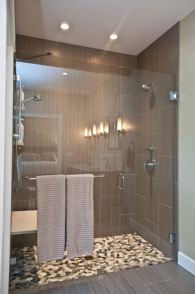 Large transitional master gray tile and ceramic tile ceramic tile drop-in bathtub photo with an undermount sink, shaker cabinets, brown cabinets, quartz countertops and gray walls