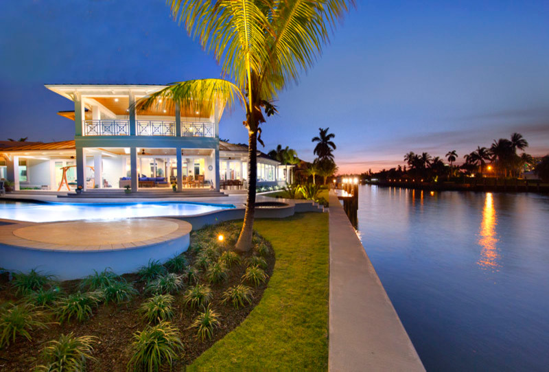 Inspiration for an expansive tropical two-storey green exterior in Miami.
