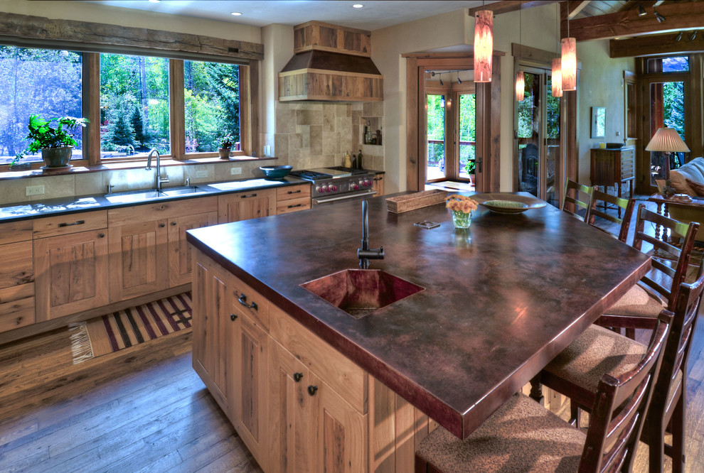 Inspiration for a large transitional open plan kitchen in Denver with copper benchtops, an integrated sink, shaker cabinets, light wood cabinets, beige splashback, ceramic splashback, stainless steel appliances, medium hardwood floors, with island and brown floor.