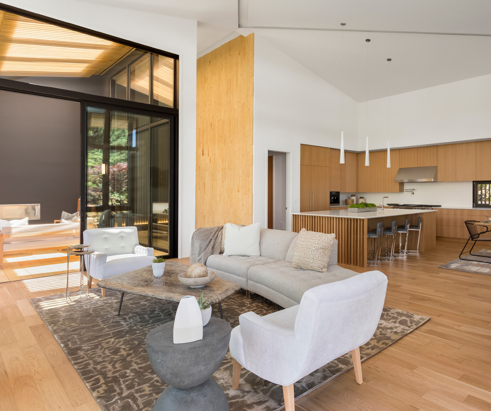 Photo of an expansive contemporary open concept living room in Portland with light hardwood floors.