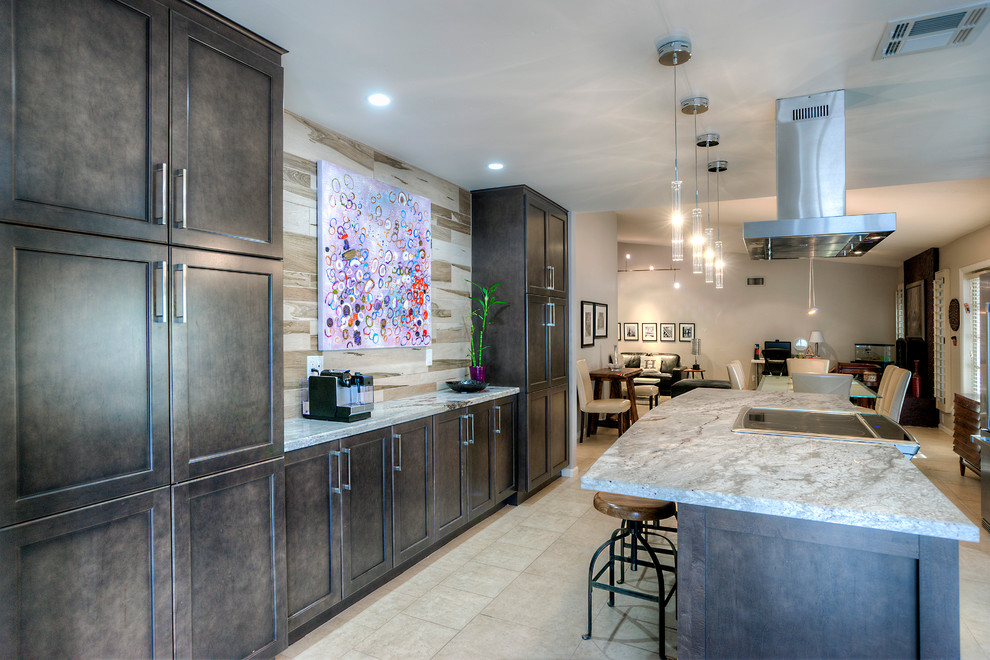 Photo of a large transitional galley eat-in kitchen in Phoenix with an undermount sink, shaker cabinets, granite benchtops, beige splashback, stainless steel appliances, with island, subway tile splashback, porcelain floors, brown cabinets, beige floor and grey benchtop.