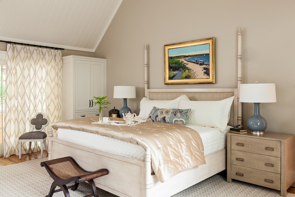 This is an example of a beach style master bedroom in Boston with beige walls.