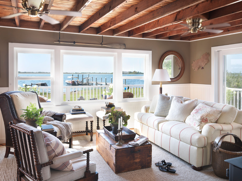 Inspiration for a beach style living room in Providence with brown walls and no tv.