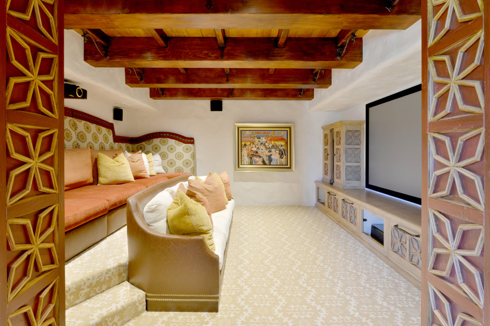 Large mediterranean enclosed home theatre in San Diego with white walls, carpet, a projector screen and multi-coloured floor.