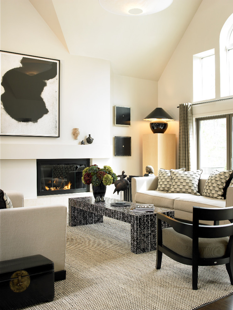 Inspiration for a mid-sized contemporary formal open concept living room in Boston with white walls, a standard fireplace, dark hardwood floors, a plaster fireplace surround and no tv.