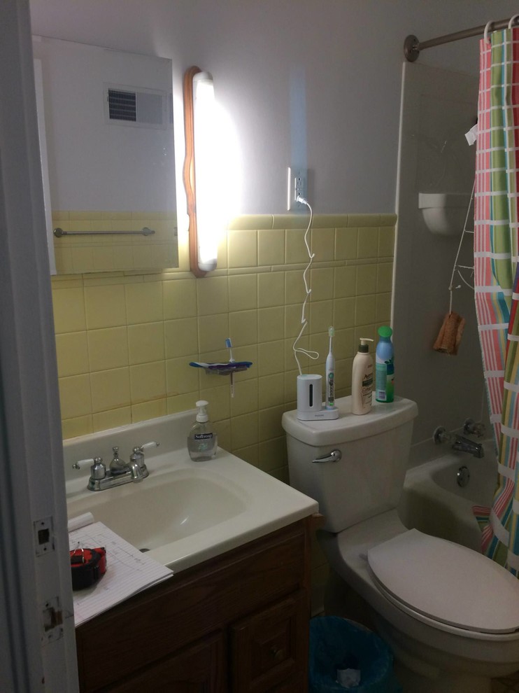 Alcove shower - small transitional master white tile and porcelain tile marble floor alcove shower idea with recessed-panel cabinets, white cabinets, a two-piece toilet, blue walls, an undermount sink and solid surface countertops