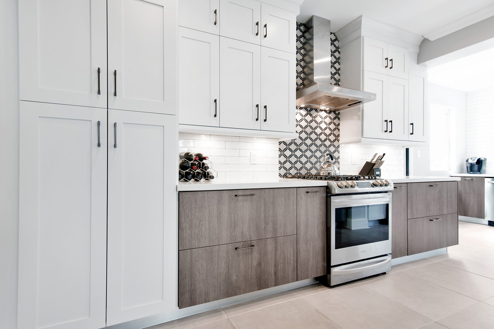 Mid-sized transitional u-shaped porcelain tile and gray floor open concept kitchen photo in Miami with a farmhouse sink, shaker cabinets, white cabinets, quartz countertops, stainless steel appliances, a peninsula and white countertops