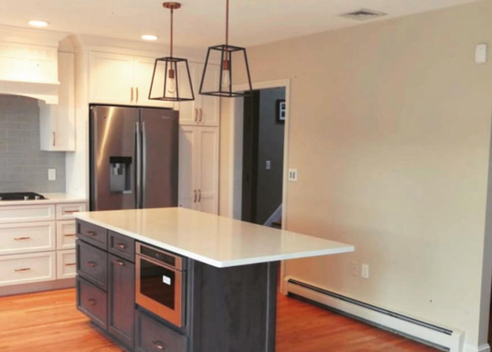 Kitchen - large transitional medium tone wood floor kitchen idea in Boston with a farmhouse sink, subway tile backsplash, stainless steel appliances and an island