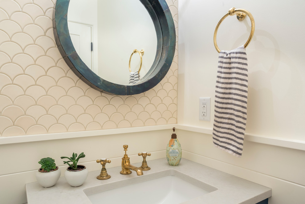 Photo of a small mediterranean 3/4 bathroom in Portland with furniture-like cabinets, blue cabinets, a one-piece toilet, beige tile, ceramic tile, white walls, dark hardwood floors, an undermount sink, engineered quartz benchtops and brown floor.
