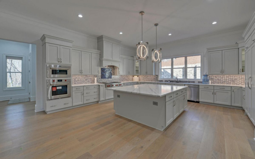 Kitchen - transitional kitchen idea in Atlanta with recessed-panel cabinets