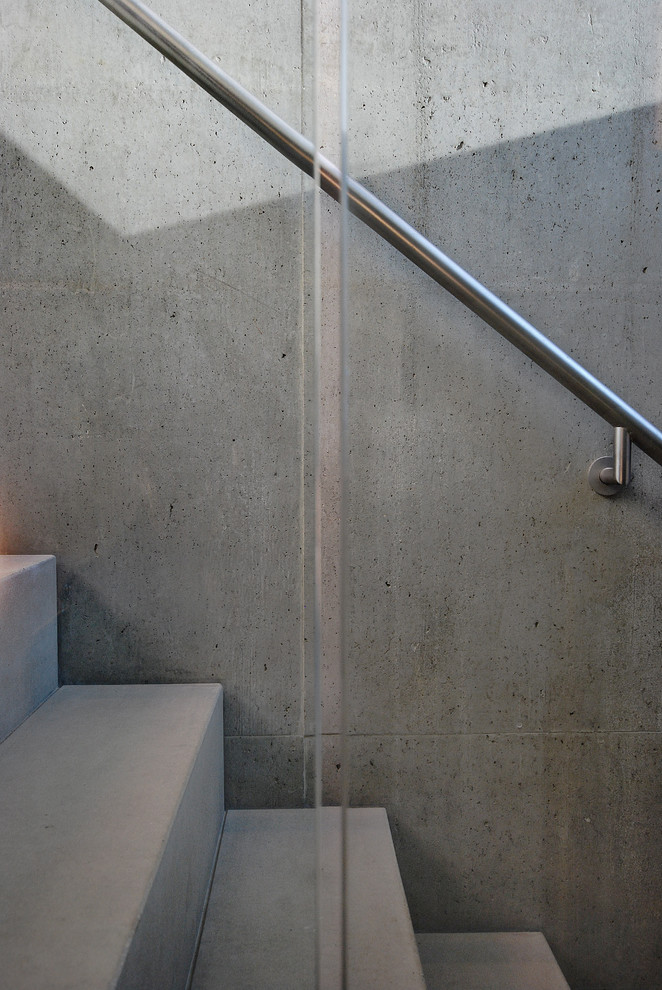 Mid-sized trendy concrete straight staircase photo in London with concrete risers