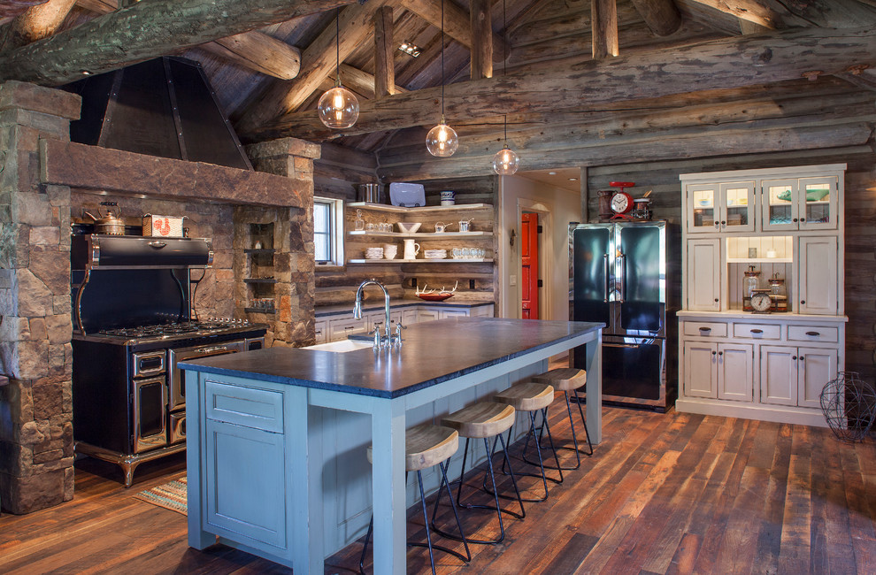 Design ideas for a country l-shaped kitchen in Denver with a farmhouse sink, shaker cabinets, distressed cabinets, dark hardwood floors and with island.