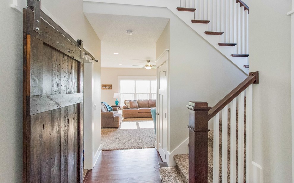 Foyer - transitional dark wood floor and brown floor foyer idea with gray walls and a blue front door