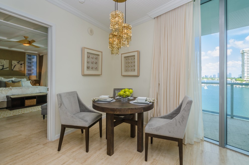 Photo of a small modern dining room in Miami with beige walls and ceramic floors.