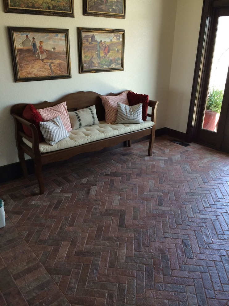 Inspiration for a mid-sized rustic brick floor and brown floor foyer remodel with beige walls and a dark wood front door