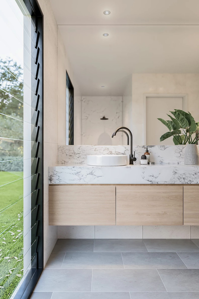 Inspiration for a mid-sized contemporary master bathroom in Perth with flat-panel cabinets, light wood cabinets, an open shower, white tile, ceramic tile, white walls, ceramic floors, a vessel sink, marble benchtops, grey floor, an open shower and white benchtops.
