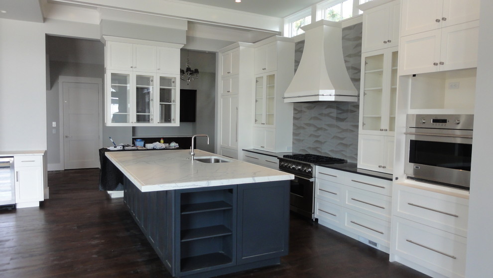 Design ideas for a contemporary l-shaped open plan kitchen in Atlanta with an undermount sink, recessed-panel cabinets, white cabinets, grey splashback and stainless steel appliances.