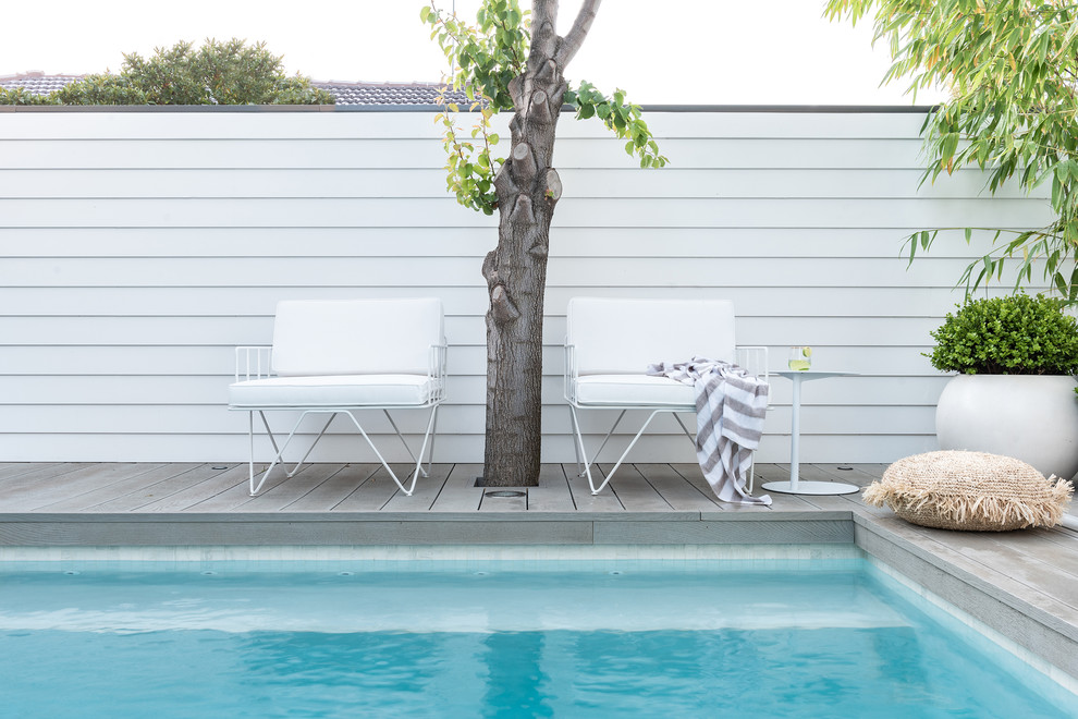 Design ideas for a small beach style backyard pool in Perth with decking.