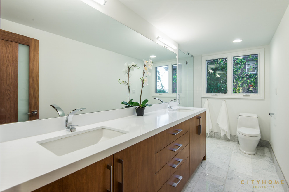 Design ideas for a large modern 3/4 bathroom in Salt Lake City with flat-panel cabinets, medium wood cabinets, a curbless shower, white tile, stone tile, white walls, marble floors, an undermount sink, engineered quartz benchtops and a drop-in tub.