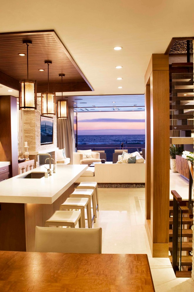 Inspiration for a contemporary galley open plan kitchen in Los Angeles with an undermount sink, flat-panel cabinets, dark wood cabinets, porcelain floors, with island, white floor, white benchtop and quartz benchtops.