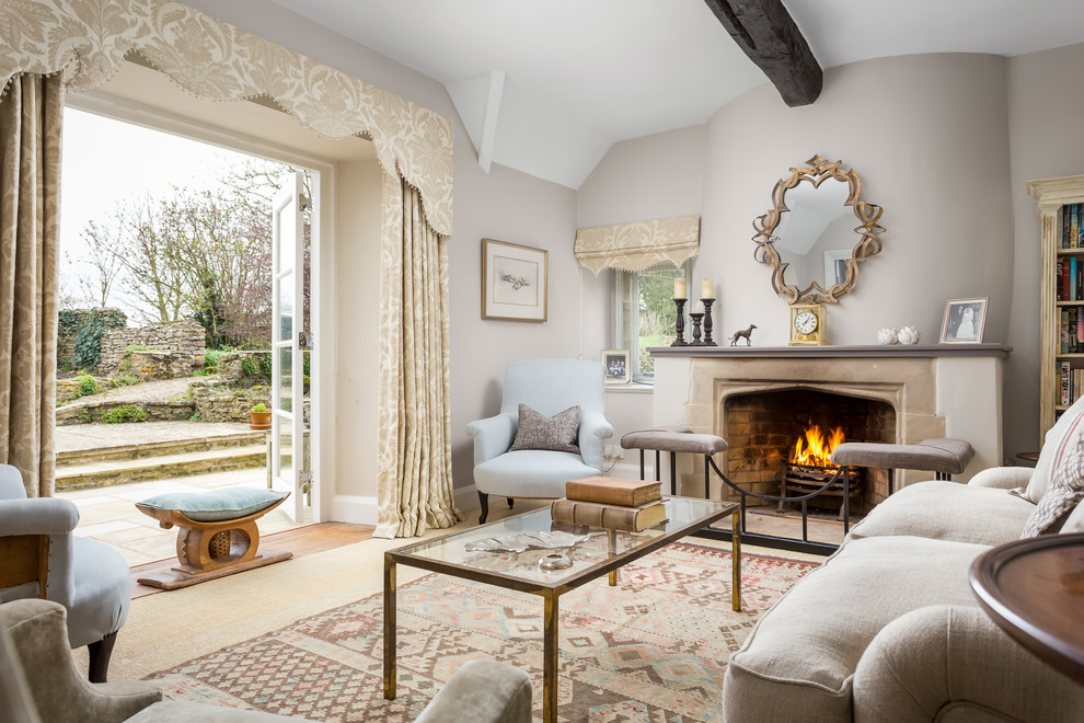 Design ideas for a country living room in Gloucestershire with a library, beige walls, a standard fireplace, no tv and beige floor.
