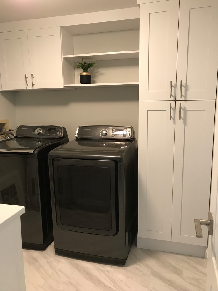 This is an example of a mid-sized transitional u-shaped dedicated laundry room in DC Metro with an undermount sink, shaker cabinets, white cabinets, quartz benchtops, grey walls, ceramic floors, a side-by-side washer and dryer, multi-coloured floor and multi-coloured benchtop.