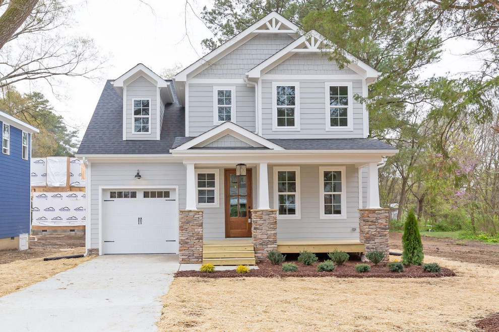 Inspiration for a mid-sized timeless gray two-story concrete fiberboard exterior home remodel in Raleigh with a shingle roof