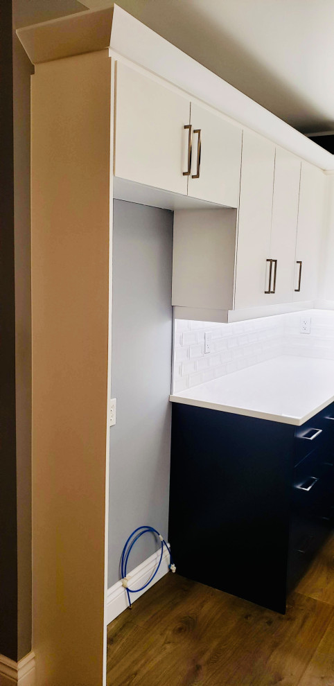Transitional u-shaped open plan kitchen in Other with an undermount sink, flat-panel cabinets, white cabinets, quartzite benchtops, white splashback, porcelain splashback, no island and white benchtop.