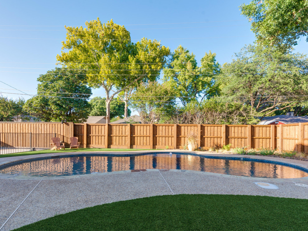 Pool - transitional backyard kidney-shaped natural and privacy pool idea in Dallas with decking
