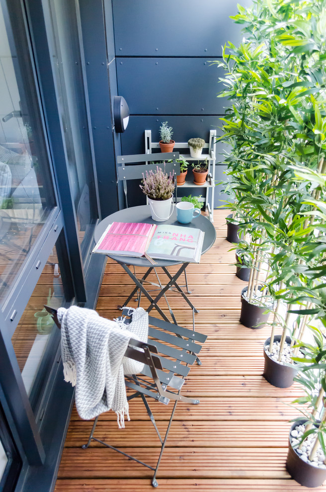 Photo of a small scandinavian rooftop deck in London with a vertical garden and a roof extension.