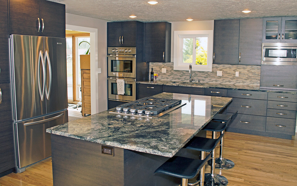 Example of a large transitional l-shaped light wood floor eat-in kitchen design in Seattle with an undermount sink, flat-panel cabinets, dark wood cabinets, granite countertops, green backsplash, glass tile backsplash, stainless steel appliances and an island