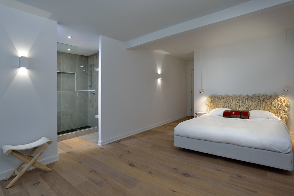 Mid-sized contemporary master bedroom in Toronto with white walls, light hardwood floors and beige floor.