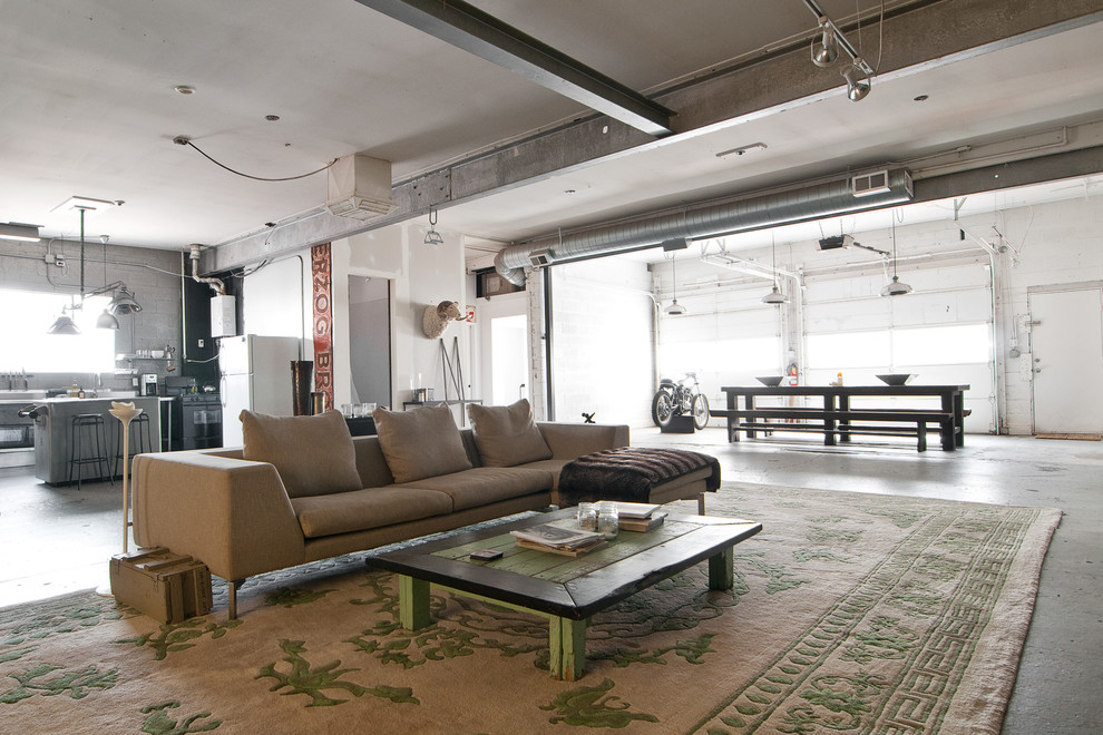 This is an example of an industrial living room in Salt Lake City with concrete floors.
