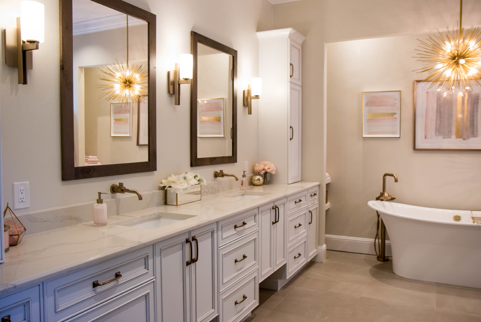 This is an example of a large transitional master bathroom in Orlando with recessed-panel cabinets, white cabinets, a freestanding tub, porcelain floors, quartzite benchtops, grey floor and white benchtops.