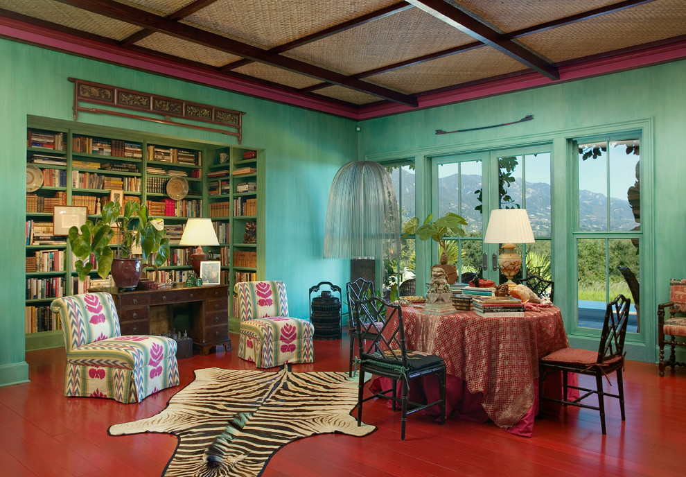 Photo of an eclectic dining room in Santa Barbara with green walls and red floor.