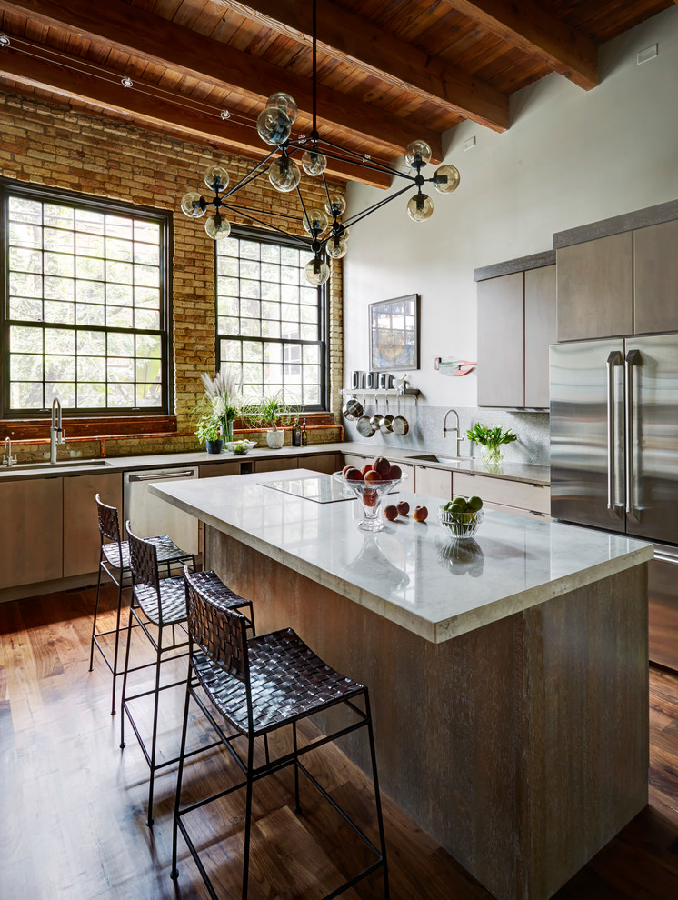 Large trendy u-shaped medium tone wood floor enclosed kitchen photo in Chicago with an undermount sink, flat-panel cabinets, gray cabinets, quartz countertops, gray backsplash, glass tile backsplash, stainless steel appliances and an island