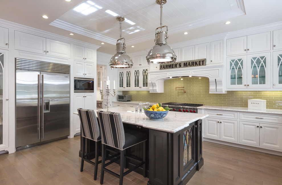 Design ideas for a large traditional kitchen in Los Angeles with raised-panel cabinets, white cabinets, green splashback, cement tile splashback, stainless steel appliances, with island, a farmhouse sink, marble benchtops and white benchtop.